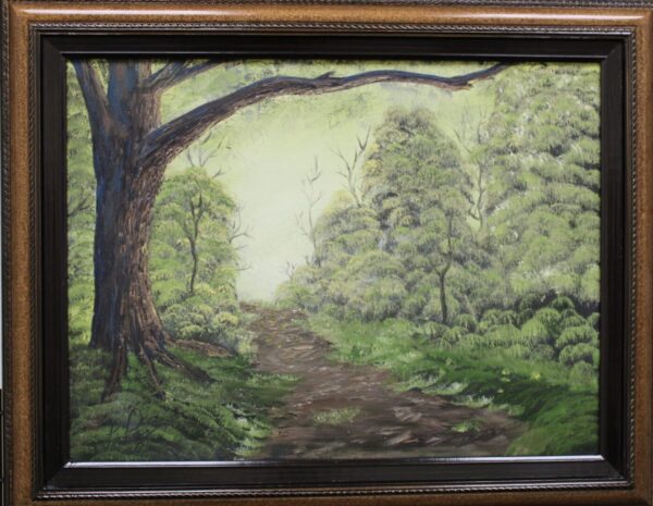 A painting of a green forest path in a brown frame