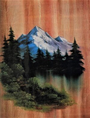 A painting of a mountain and lake on wood.