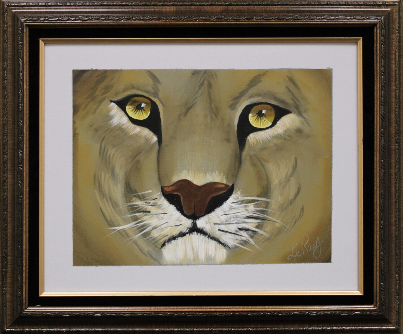 A framed painting of a lion’s face up close