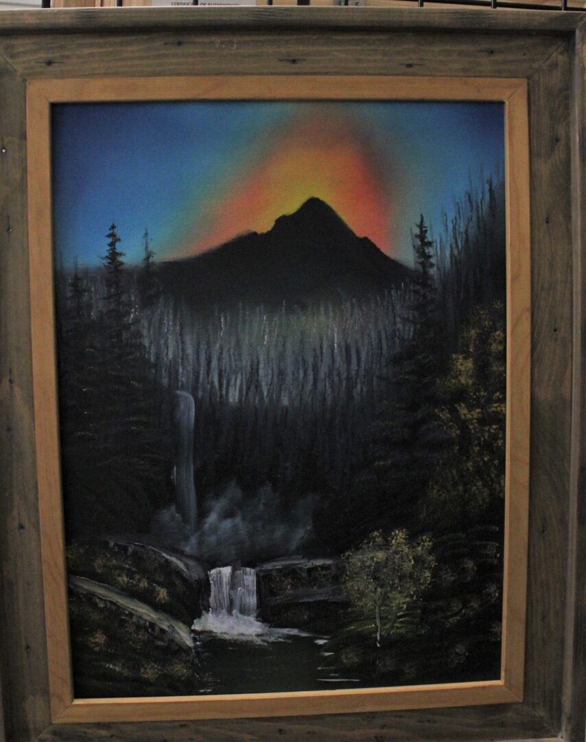 A painting of Morning Falls in a wooden frame.