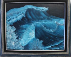 A painting of a blue ocean Wave in a black frame.