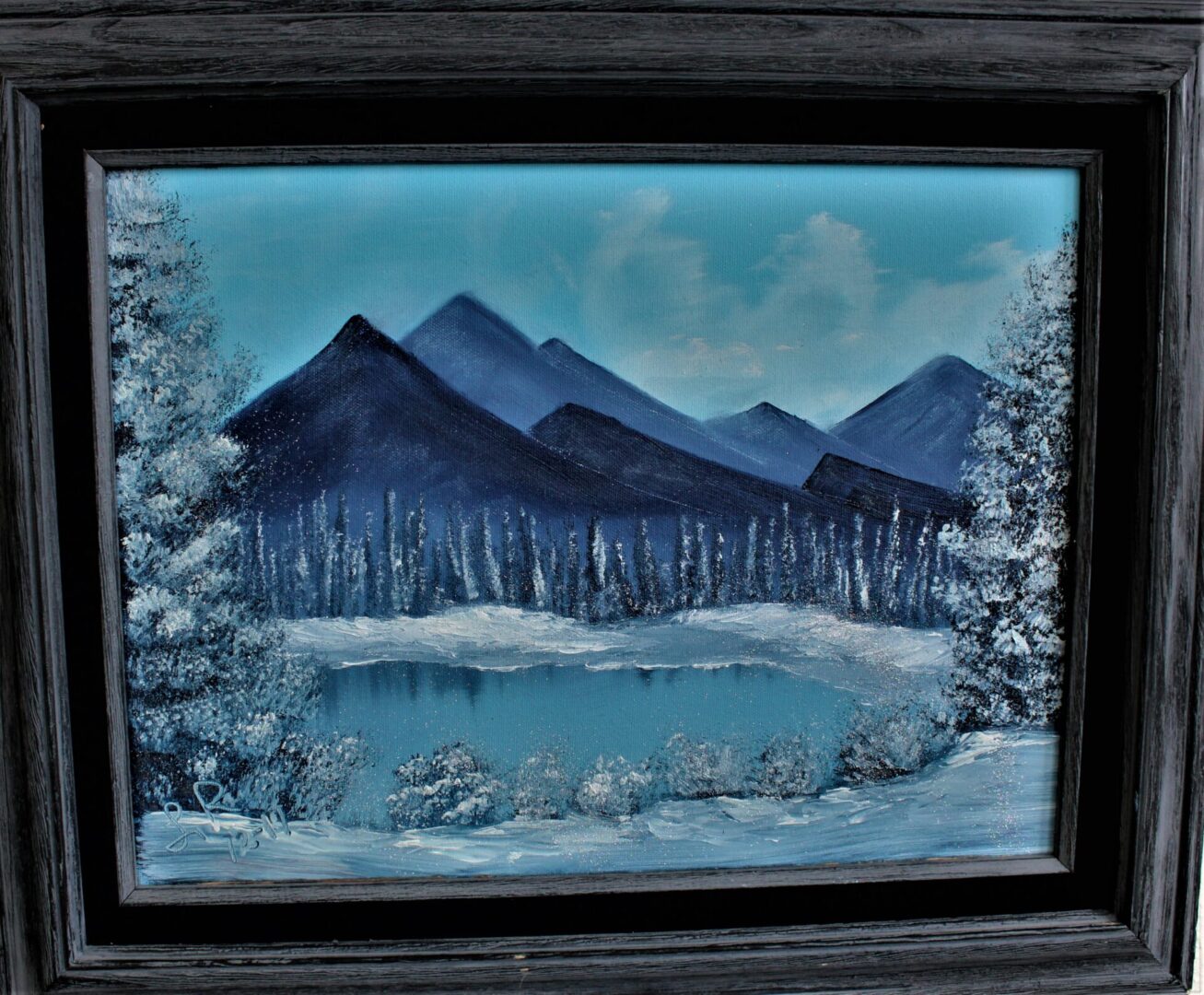 Painting of a mountain with snow scenery with a black frame