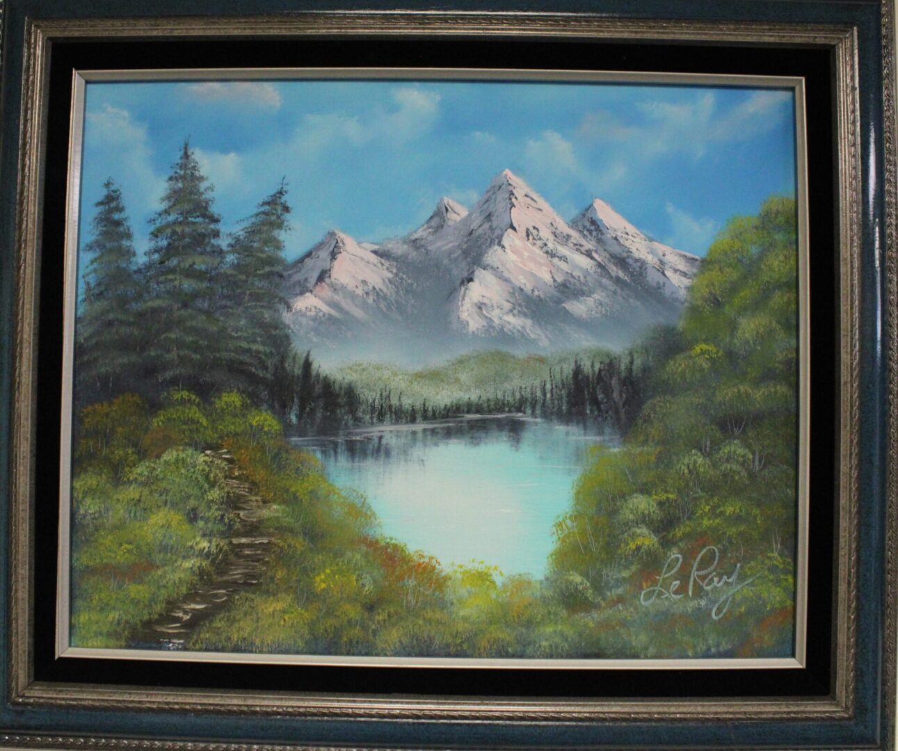 Painting of a mountain scenery with a black color frame