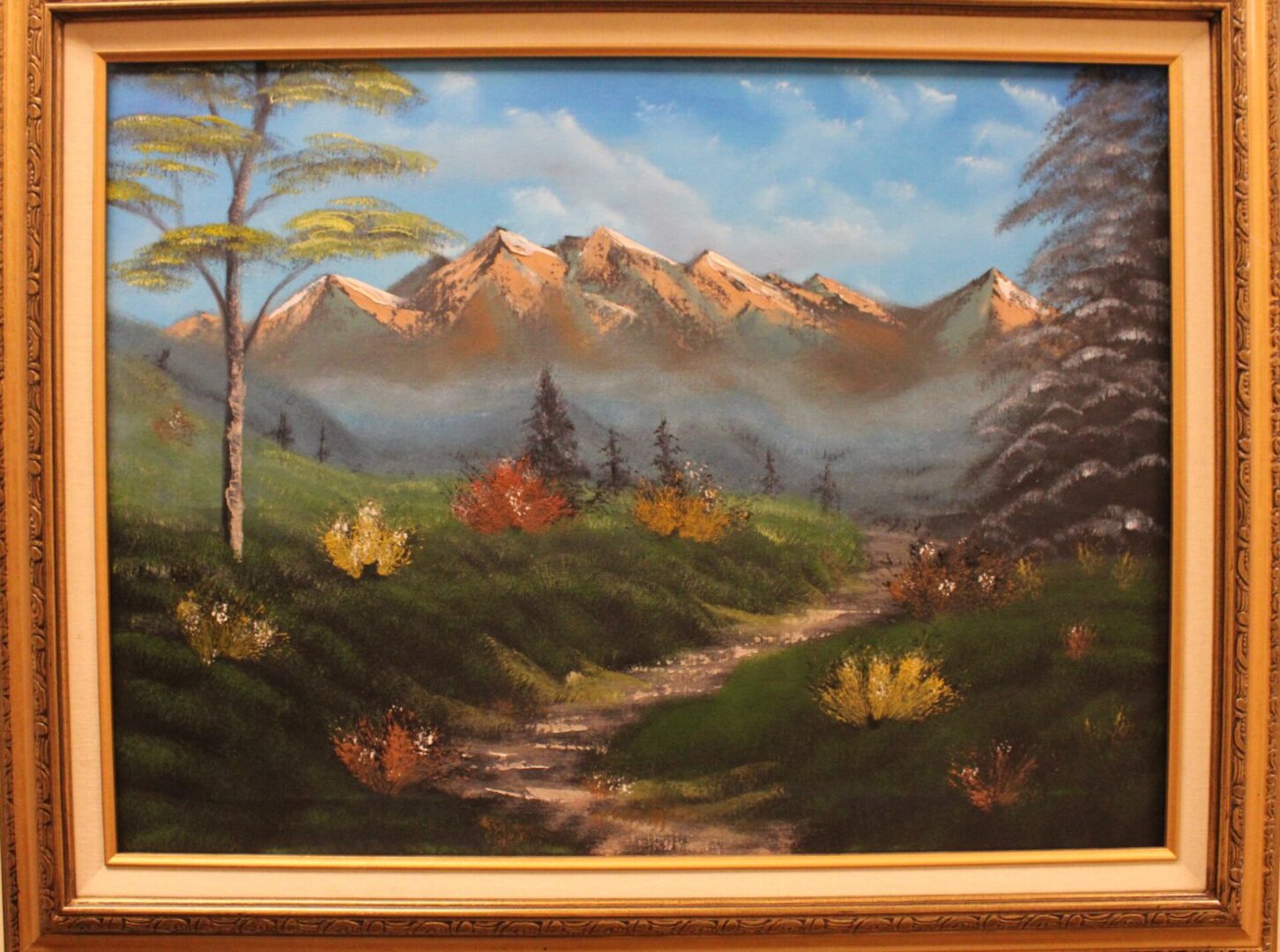 Painting of a mountain scenery with a orange frame